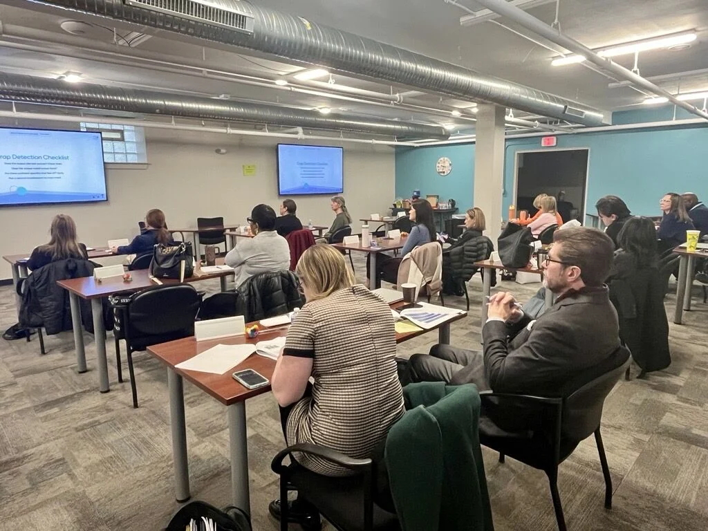 Attendees sit at classroom tables during the introductory AI training.